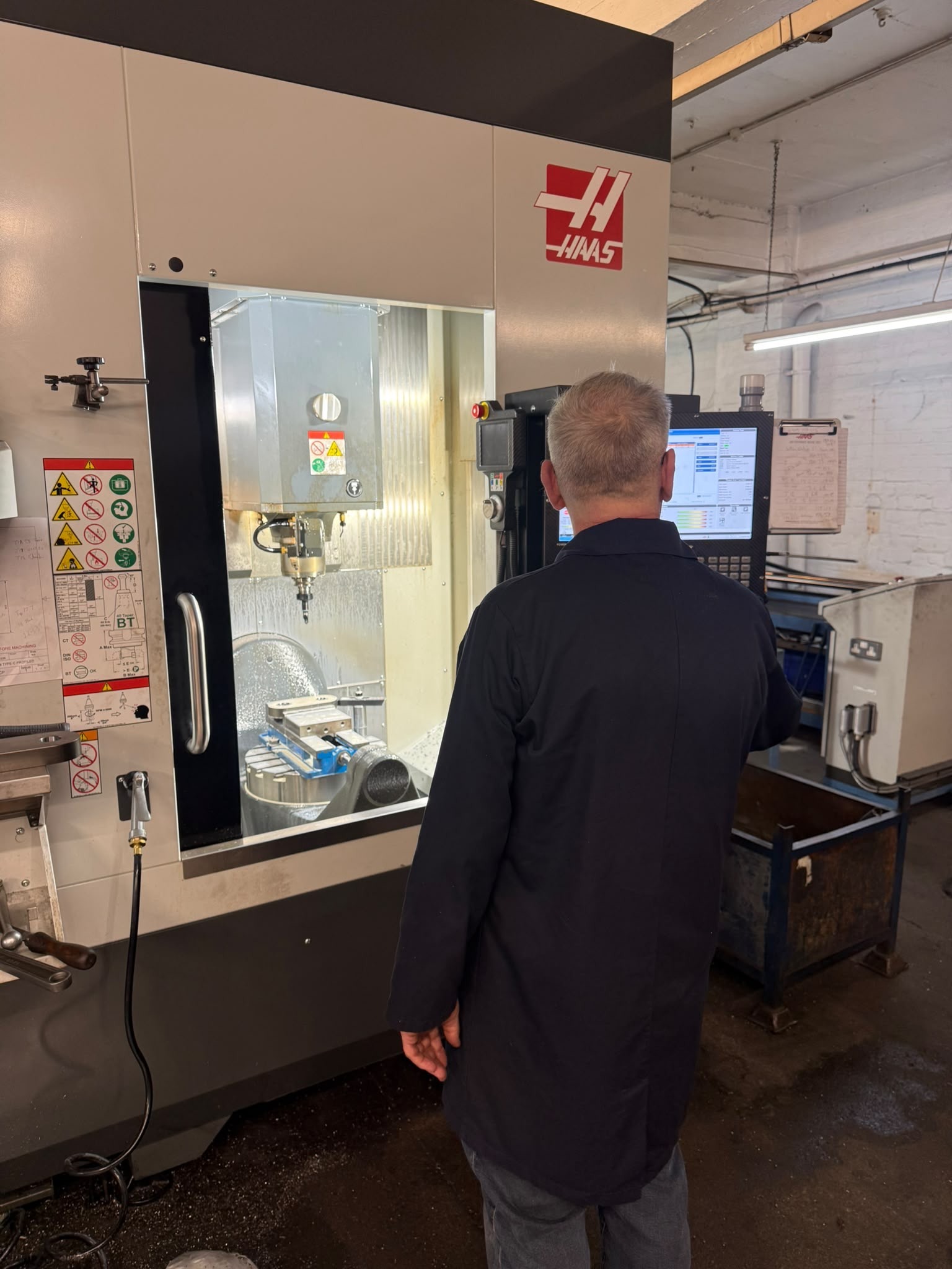 Operator working at Haas CNC machining centre at Arcadian Products