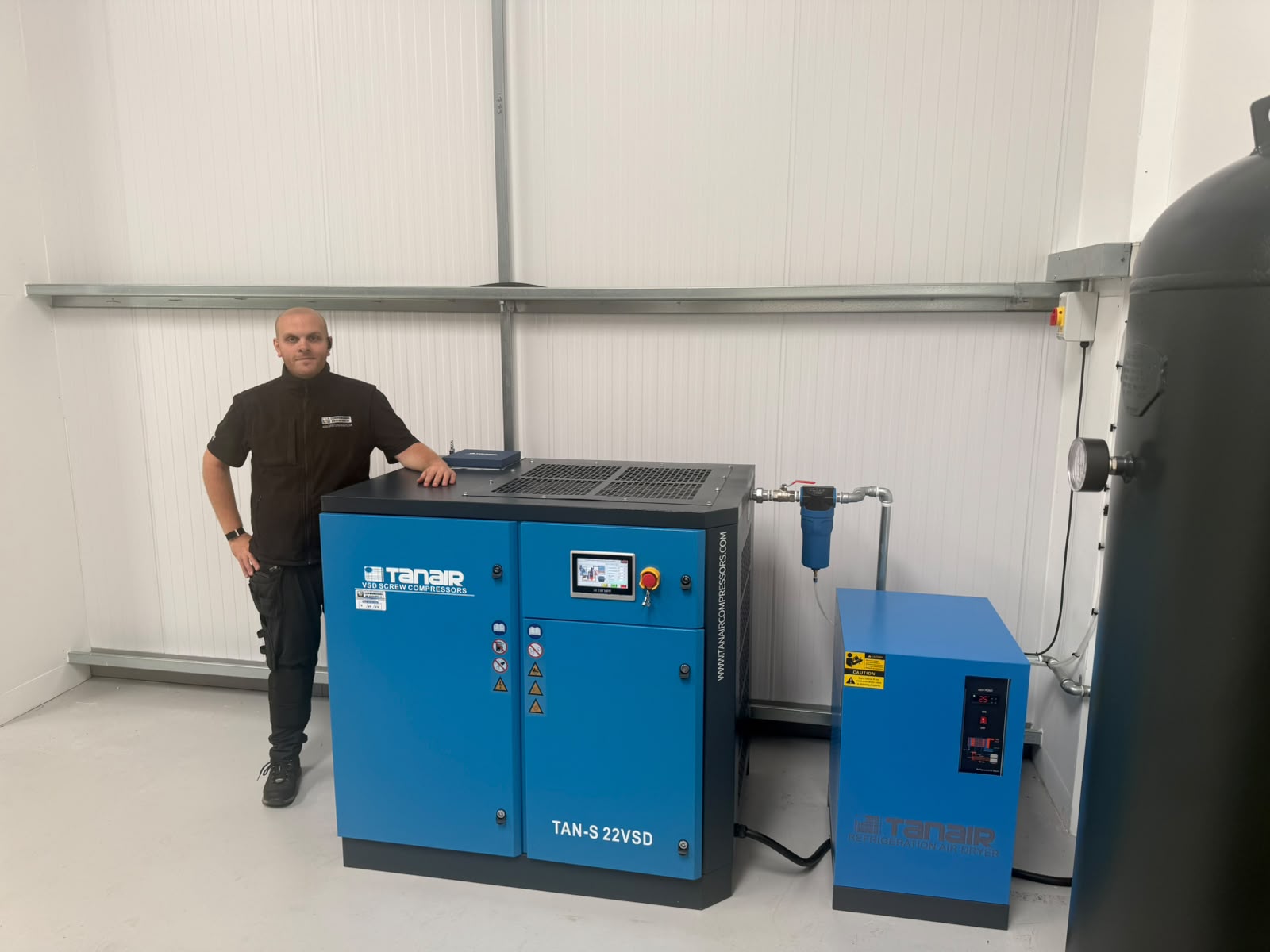 Compressed Air Systems UK engineer beside the Tanair compressor at KUT Machinery